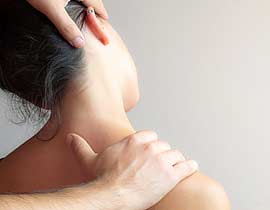 A chiropractor's hands working on a patient's neck.