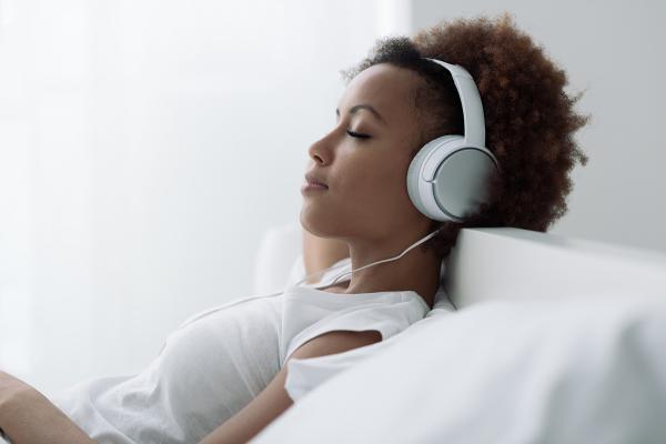 A woman listening to headphones.